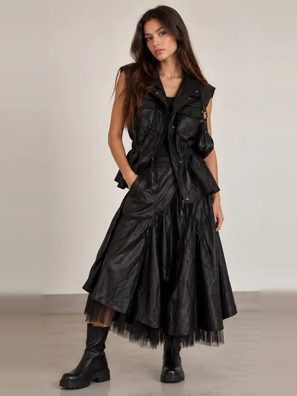 Black leather vest over a layered tulle skirt, front